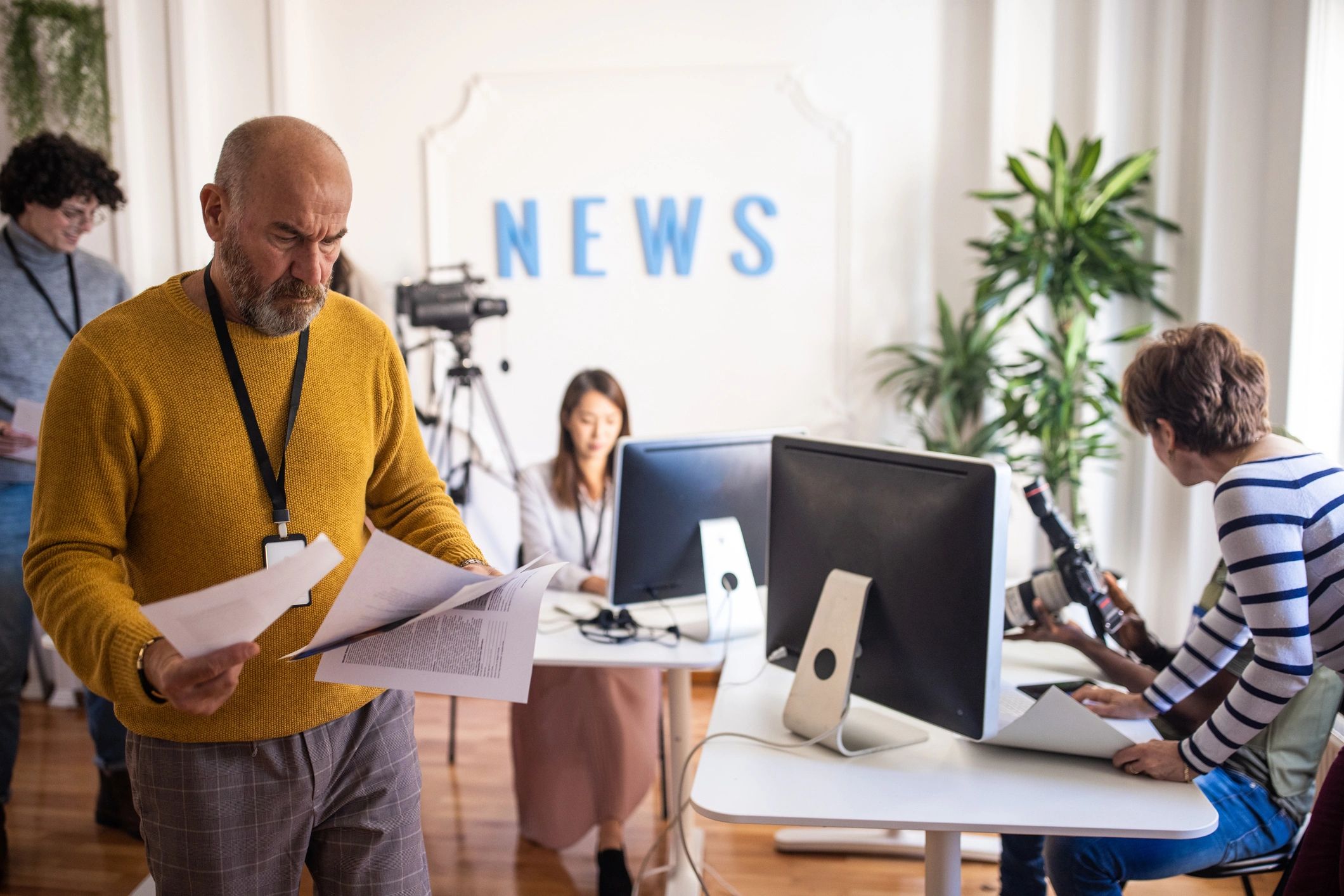 Journalists collaborating in a modern newsroom