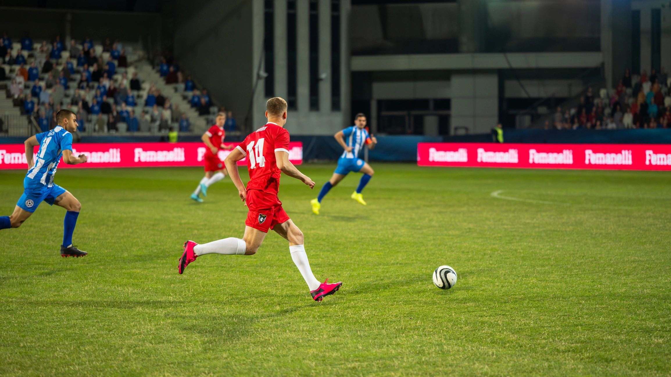 Soccer players running with the ball