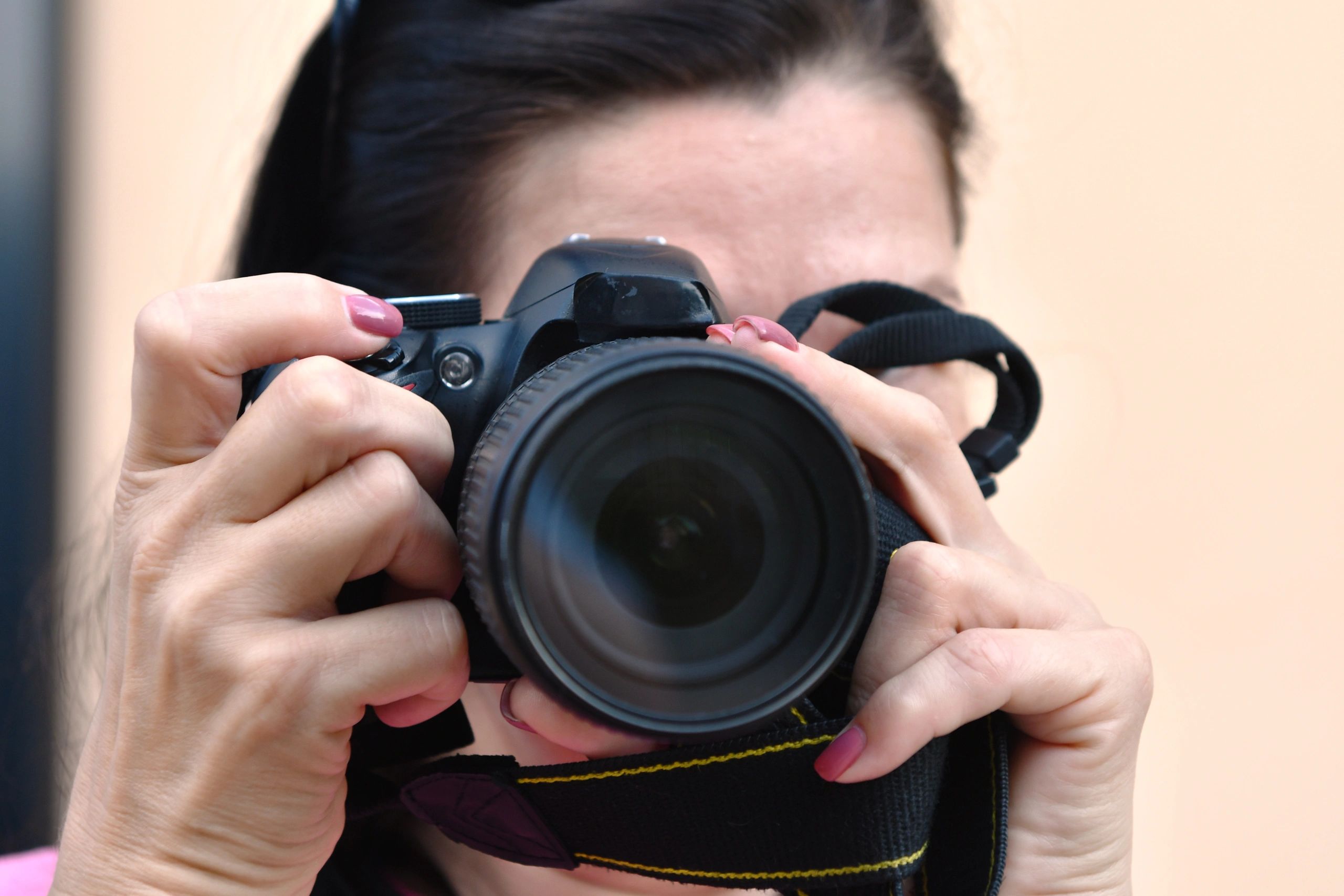 Girl photographer holding a DSLR camera
